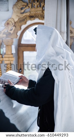 jewish prayer with tallit and tefillin Royalty-Free Stock Photo #610449293