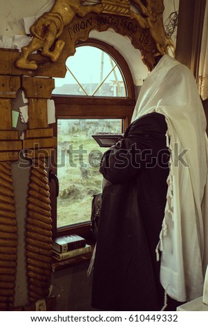 jewish prayer with tallit and tefillin Royalty-Free Stock Photo #610449332