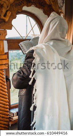 jewish prayer with tallit and tefillin Royalty-Free Stock Photo #610449416