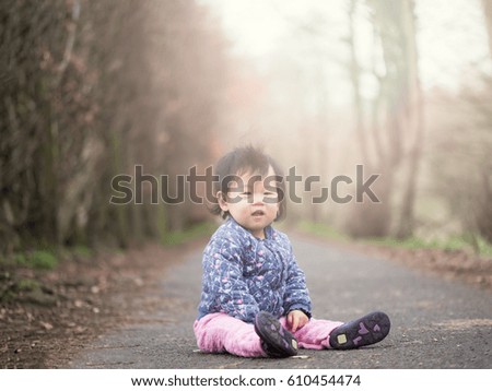 baby girl playing outdoor in spring time
