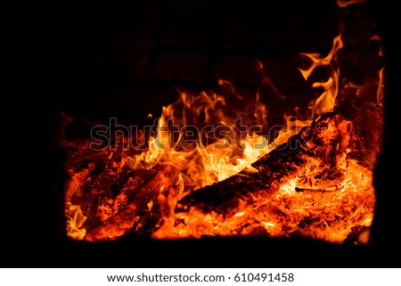 bright flame of fire burns in a fireplace