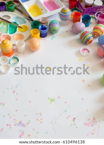 Colorful pastel easter eggs on wooden board background with space.