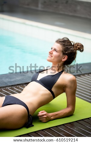 Smiling Woman Sunbathing Near Swimming Pool