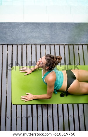 Smiling Woman Lying on Mat and Stretching Back