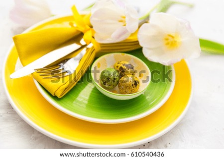 Easter table setting with flowers and cutlery. Holidays background