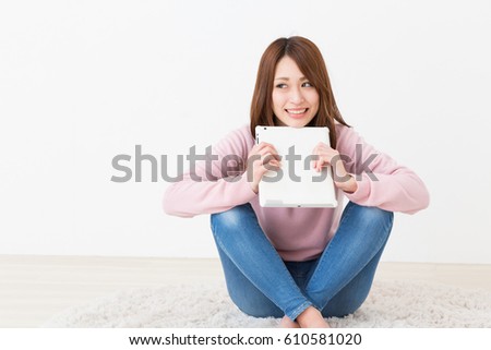 young attractive asian woman to see a tablet computer