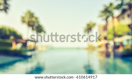 Summer blur background resort hotel swimming pool party relaxation with blue cool sky and tropical palm tree