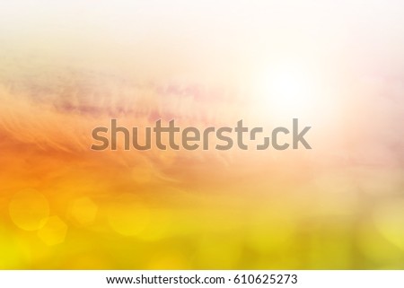 white fluffy clouds in the blue sky abstract background.Natural background blurring.warm colors and bright sun light.glitter celebration .