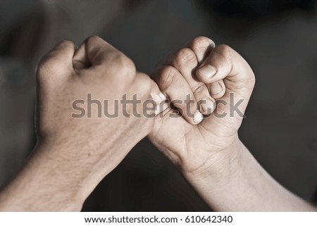 Two human fist in symbolic gesture of power.