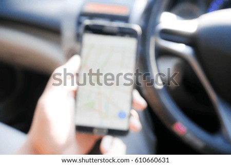 BLURRED BACKGROUND USE SMARTPHONE IN CAR