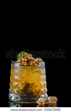 Cocktail in a glass goblet on a black background.