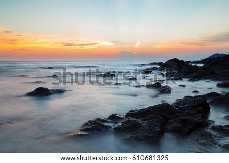 Beautiful sunset on the sea and beach, long time exposure image style.