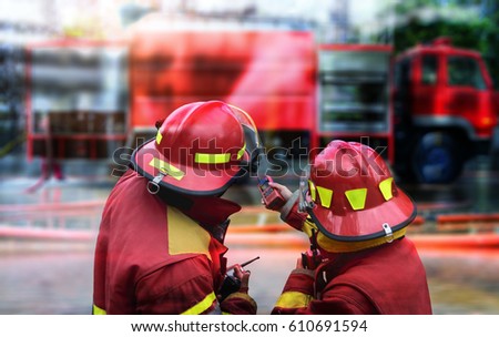 Double exposure of  Fireman team in action fire fighting .