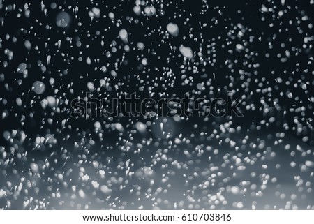 High resolution falling snow isolated on black background . Design element