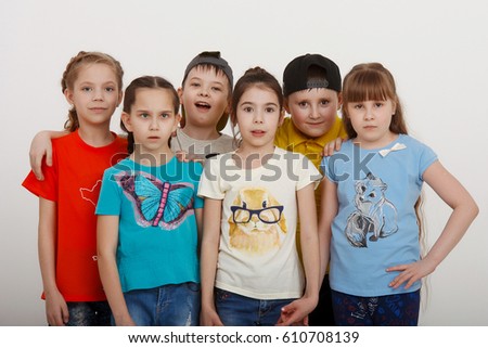 a group of children in color clothes on a white background in Studio