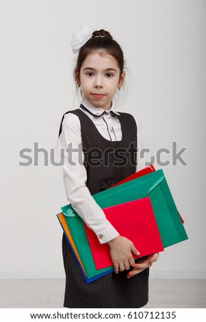 portrait of a young girl in a school uniform  on white background vertical shot in the Studio