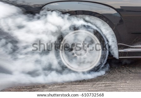 Dragster Car Burn Out Rear Tyre With Smoke Royalty-Free Stock Photo #610732568
