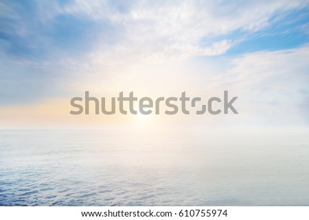 The blur cool sea background on horizon tropical sandy beach; relaxing outdoors vacation with heavenly mind view at a resort deck touching sunshine, sky surf summer clouds and light blue wave ocean.