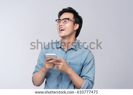 Smart casual asian man using smartphone in studio background Royalty-Free Stock Photo #610777475
