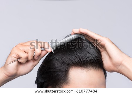 Close up photo of clean healthy man's hair. Young man comb his hair Royalty-Free Stock Photo #610777484
