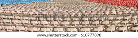 Empty colorful plastic chairs. Open air hall for concerts and festivals. Back view. Panoramic Background