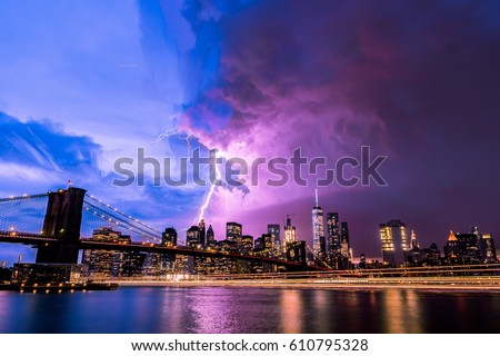 Lightning strike through New York City from Brooklyn bridge perspective. 