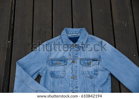 Back jean jacket ,shirt –wooden background