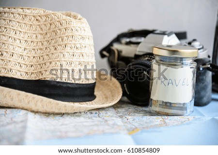 travel concept with maps, hat and camera on white background