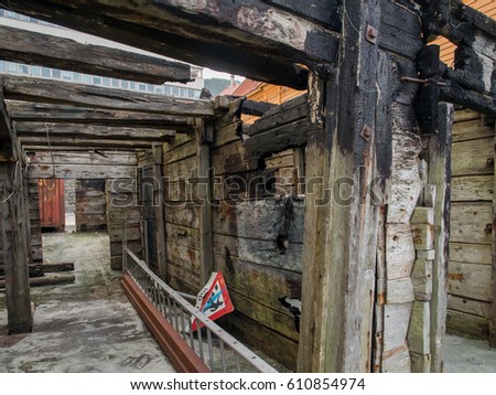 The walls of wood burnt house on the shore of a  fjord in Bergen