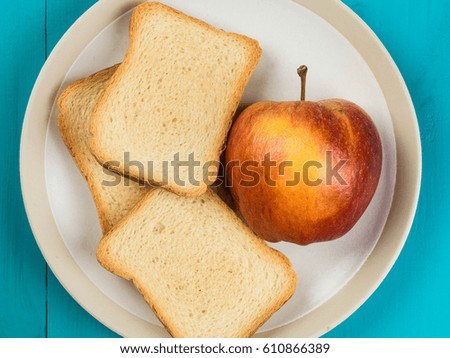 Fresh Apple With French Toast Against a Blue Background