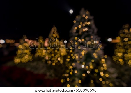 abstract blur image of christmas tree with black background.  