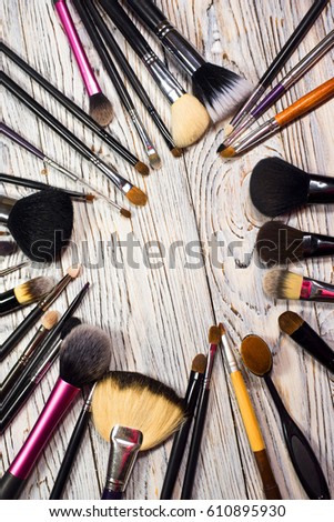 collection of cosmetics for make-up artist. Brush set. Studio photo on a wooden background with free space