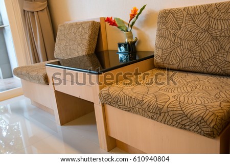 Beautiful of Flower vase on glass table with signs No smoking and modern sofa om living room