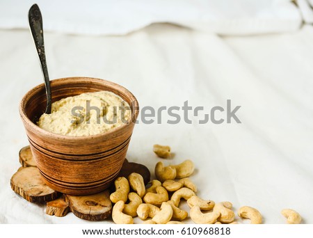 Cashew sauce, raw vegan cheese from nuts with nutritional yeast. Dairy free. Healthy or diet food concept.  Rustic Royalty-Free Stock Photo #610968818