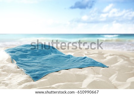 Towel on hot sand of free space for your decoration and landscape of sea  Royalty-Free Stock Photo #610990667