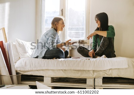 Two Girls Using A Smartphone In The Bedroom