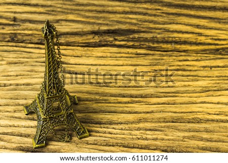 Eiffel tower replica on wooden background.