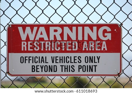 Restricted Area sign on metal fence