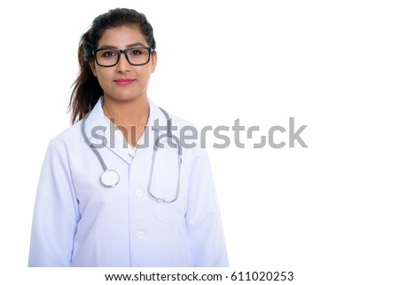 Studio shot of young beautiful Persian woman doctor with eyeglasses isolated against white background