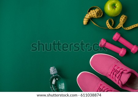 Workout plan with fitness food and equipment on green background, top view