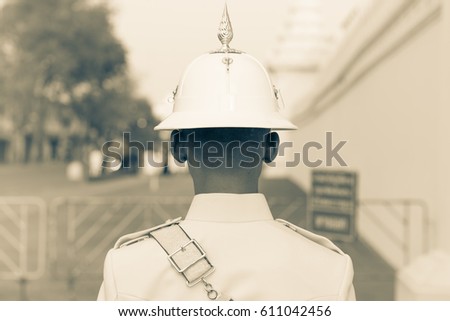 Thailand Army soldier. Guardsman of the Royal Palace from the back in Bangkok, black and white. Portrait of a Thai soldier, no face Royalty-Free Stock Photo #611042456