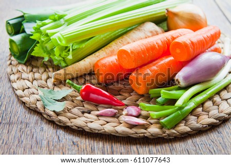 Fresh ingredients for veggie stock : carrots, celery, leeks, onion, carrots, parsnip, parsley, garlic, bay leaves, peppercorns, chili. Spring, summer products, seasonal vegetables to make your soup.