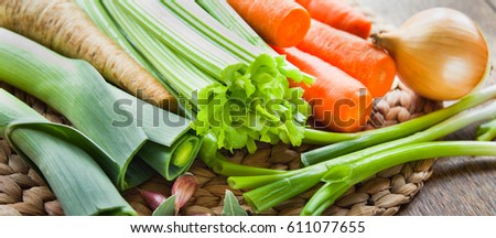Fresh ingredients for veggie stock : carrots, celery, leeks, onion, carrots, parsnip, parsley, garlic, bay leaves, peppercorns, chili. Spring and summer products, seasonal vegetables to make your soup