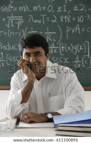 teacher sitting at his desk