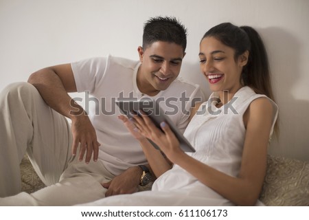 Singapore, Young man and woman using digital tablet
