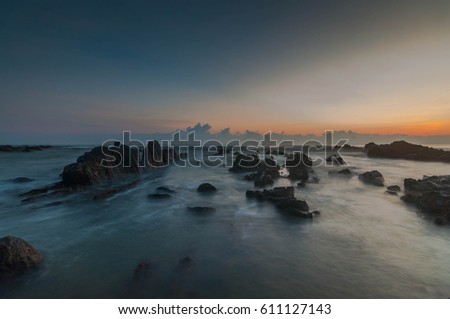 The long exposure at the Pandak Beach-a well-known sunrise port located at Tereangganu, Malaysia. Nature composition with the slow motion of water with the effect blur of water.