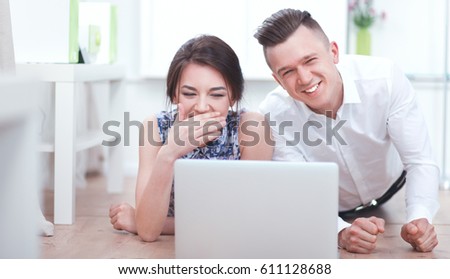 Happy young couple sitting together