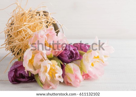Pink purple tulips in tin bucket on a wooden background. Pastel colors, greeting card concept