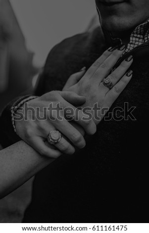 Engaged or Married Couple Embrace Hands in Black and White