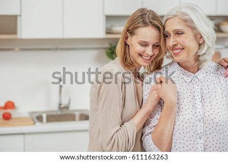 Cute young daughter embracing her mother with love Royalty-Free Stock Photo #611163263